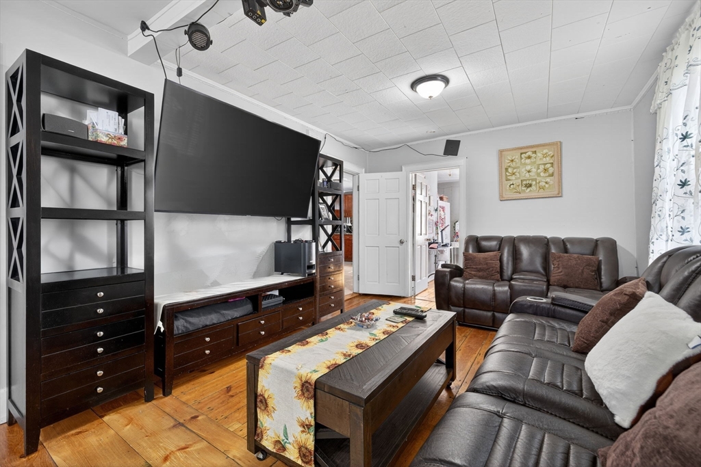 6 Morris Street Lynn, MA 01905 - Photo 8 of 36 a living room with furniture and a flat screen tv