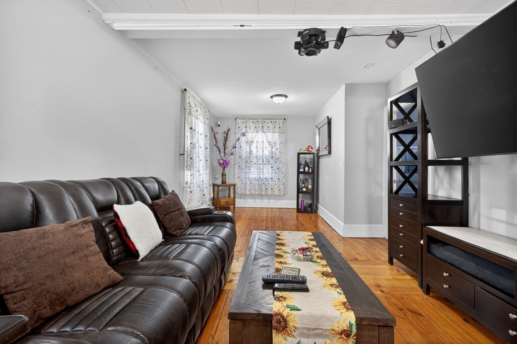 6 Morris Street Lynn, MA 01905 - Photo 9 of 36 a living room with furniture and a flat screen tv
