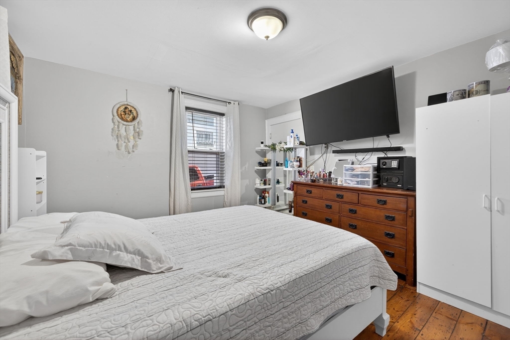 6 Morris Street Lynn, MA 01905 - Photo 10 of 36 a bedroom with a bed and a flat screen tv