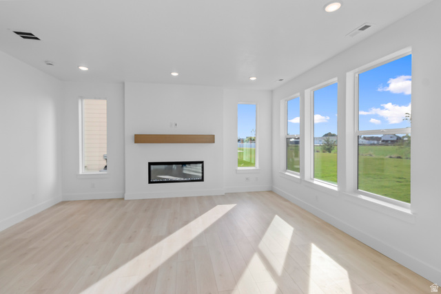1209 West 500 South, Unit 146 Logan, UT 84321 - Photo 10 of 32 Contemporary living space featuring a built-in electric fireplace with a floating wood mantel, recessed lighting, and light wood-finish flooring