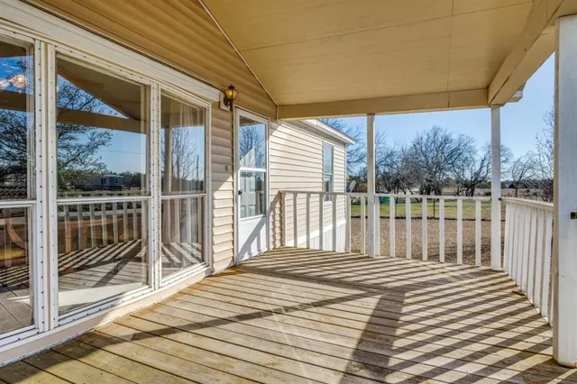 a view of a balcony with wooden floor