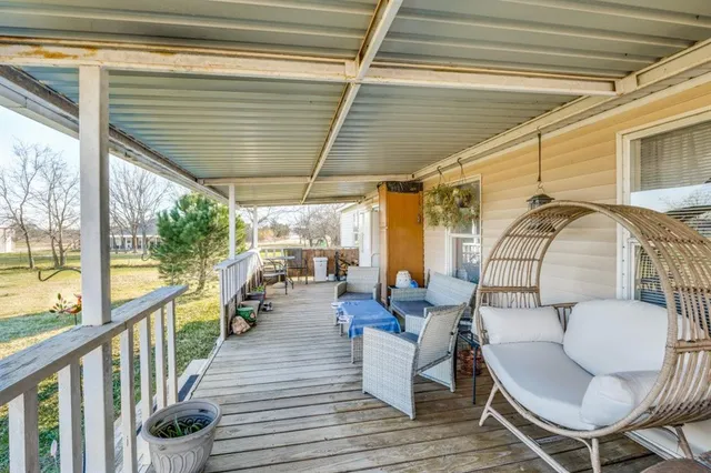 a balcony with chairs and a table