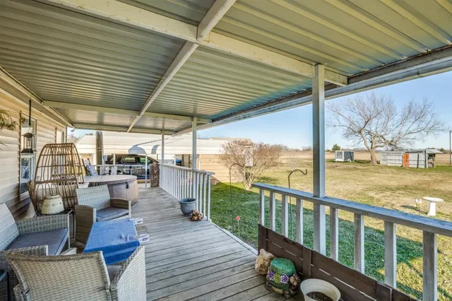 a view of a balcony with chairs and wooden floor