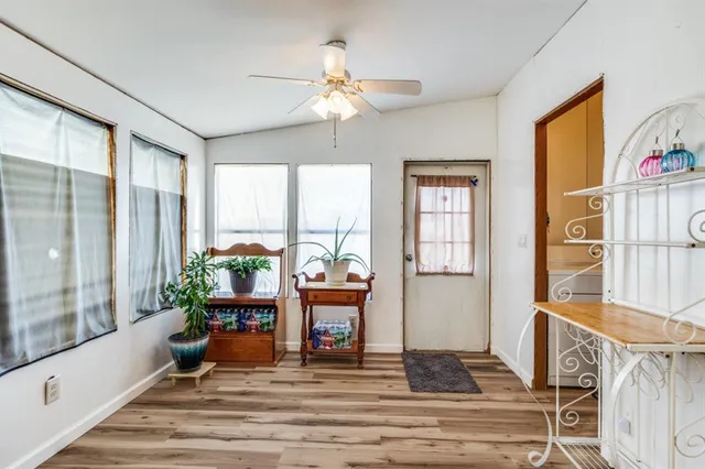 a living room with fireplace furniture and a large window