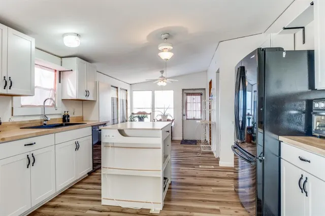 a kitchen with sink cabinets and refrigerator