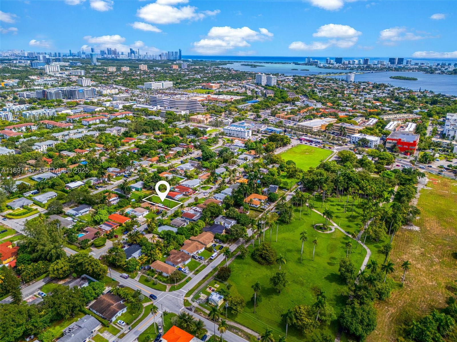 1453 Northeast 117th Street Miami, FL 33161 - Photo 15 of 15 an aerial view of residential houses with outdoor space and trees