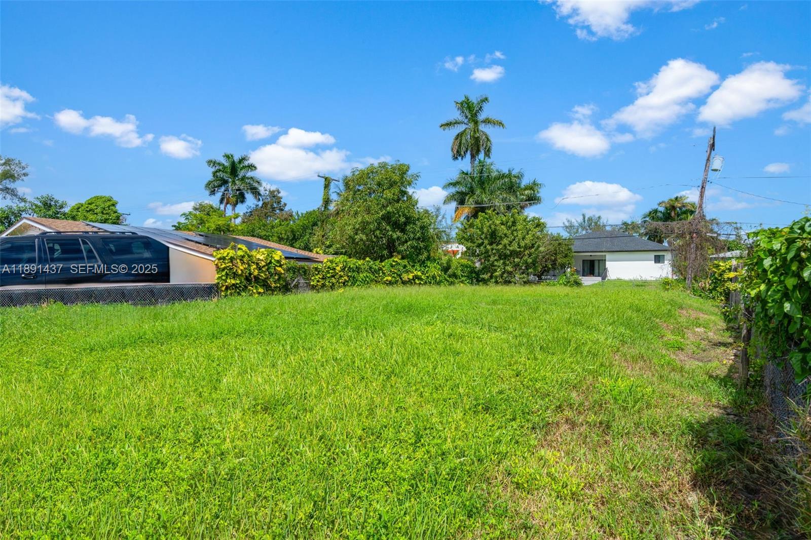 1453 Northeast 117th Street Miami, FL 33161 - Photo 2 of 15 a view of a house with a big yard and potted plants