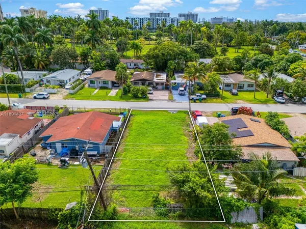 an aerial view of a houses with a yard
