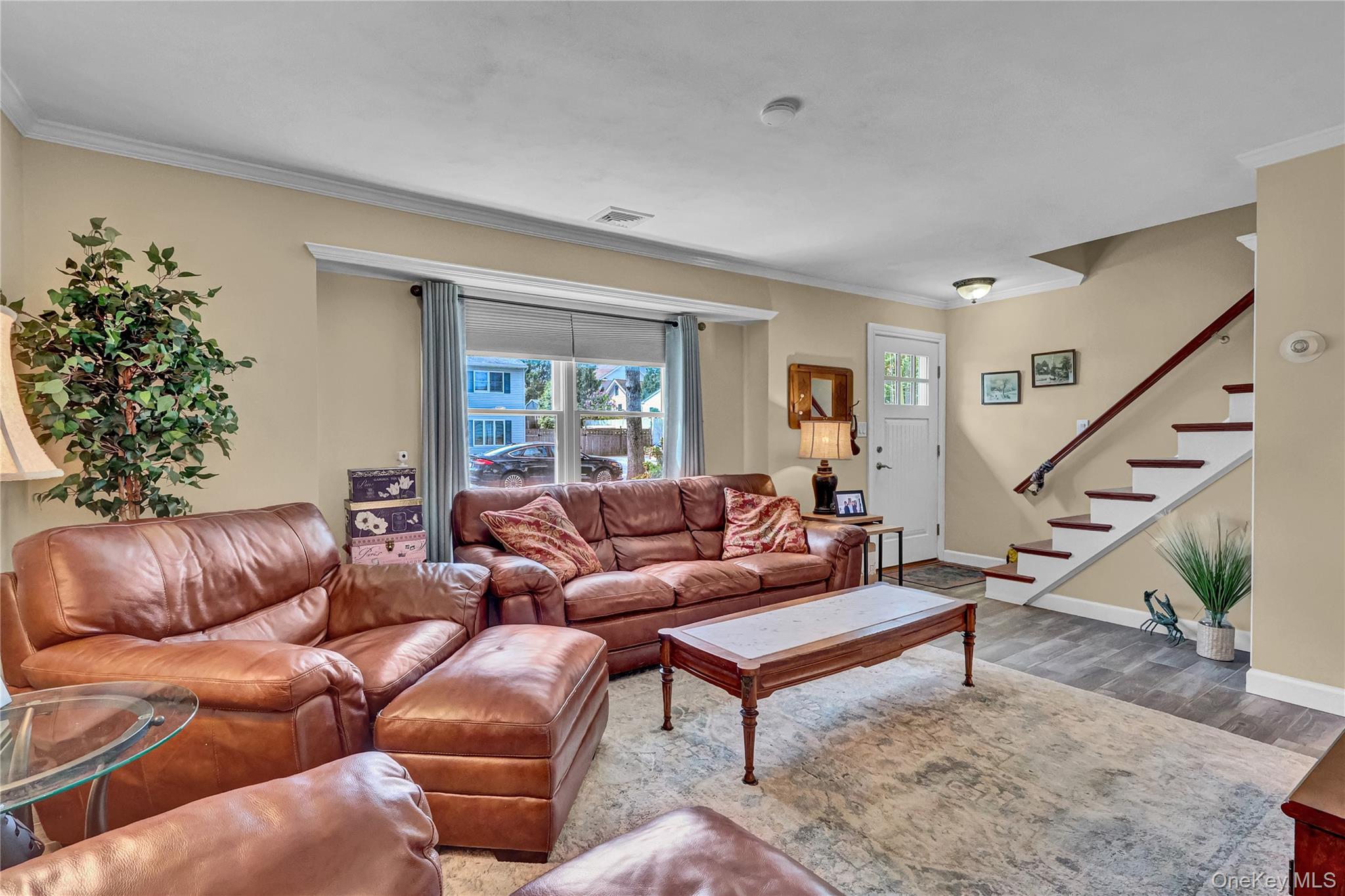 171 Prince Road Rocky Point, NY 11778 - Photo 11 of 35 Spacious living room featuring beautiful wood look tiled flooring, sunny south facing windows