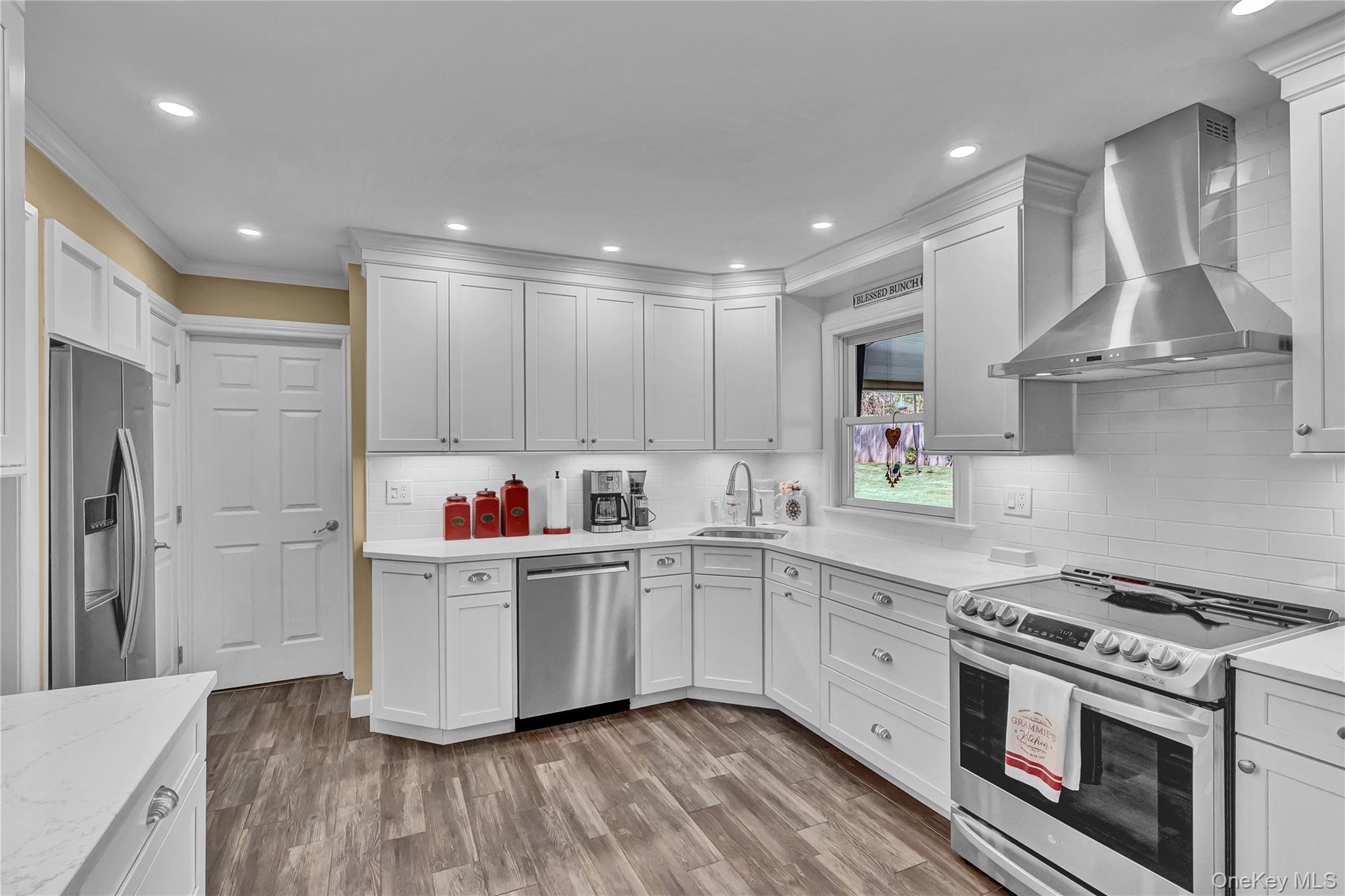 171 Prince Road Rocky Point, NY 11778 - Photo 17 of 35 Stunning white kitchen has quartz countertops and all stainless steel appliances