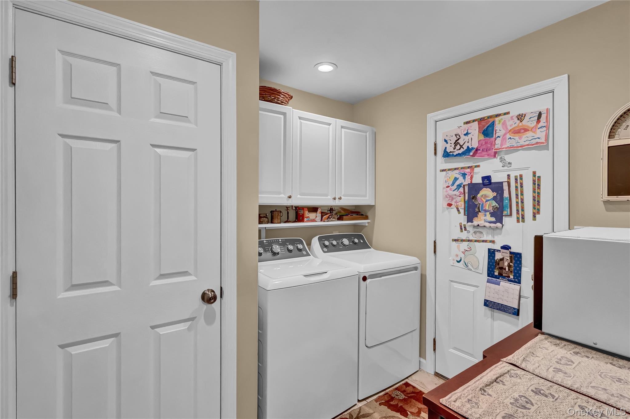 171 Prince Road Rocky Point, NY 11778 - Photo 19 of 35 Large laundry room conveniently sits just off the kitchen with an entrance to the attached garage and a door to the backyard
