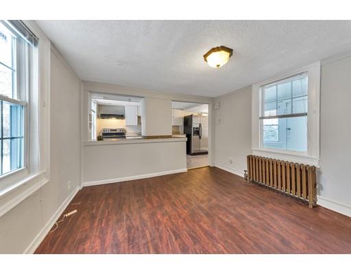 107 Cedar Street Springfield, MA 01105 - Photo 3 of 29 a view of an empty room with a window and wooden floor