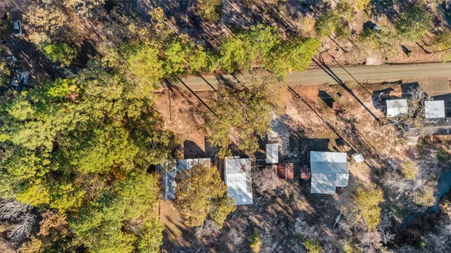 a view of a yard with wooden fence