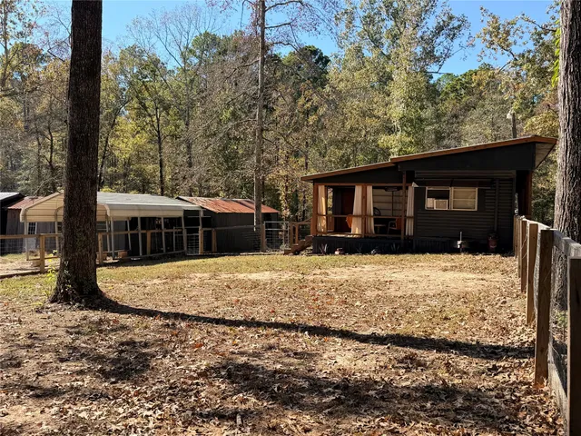 a view of a house with a tree in front of it