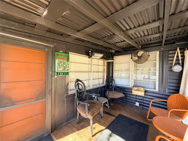 a kitchen with stainless steel appliances a sink dishwasher a refrigerator a stove and white cabinets with wooden floor