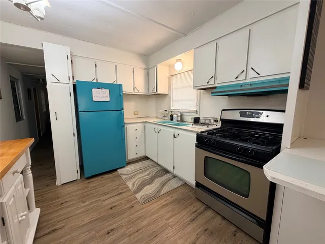 a kitchen with a sink cabinets and counter top space
