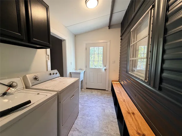 a bed sitting in a spacious bedroom next to a window