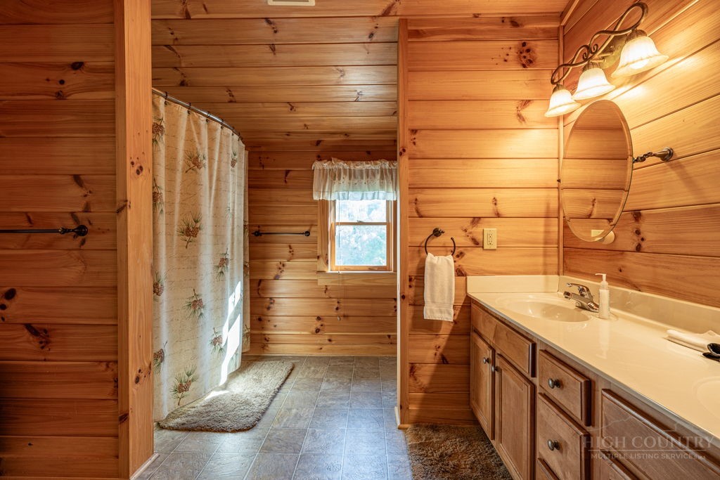 197 Woodby Ridge Road Vilas, NC 28692 - Photo 29 of 45 a bathroom with a sink and shower