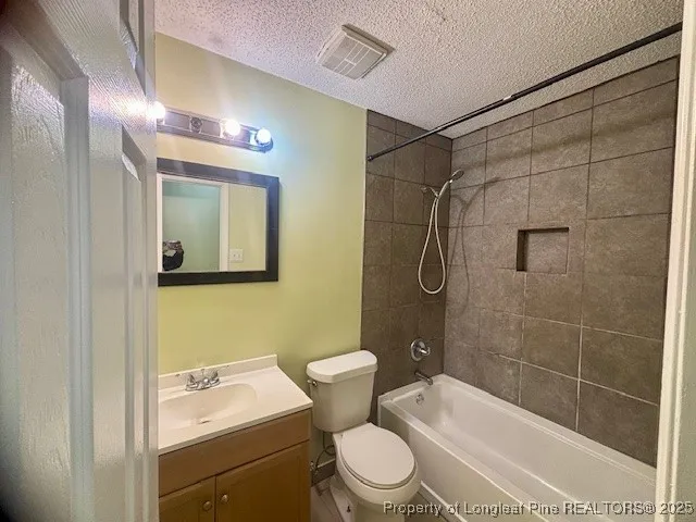 a bathroom with a toilet sink vanity shower and mirror