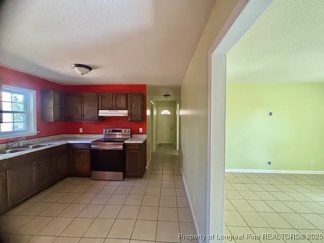 a kitchen with stainless steel appliances granite countertop a sink and cabinets