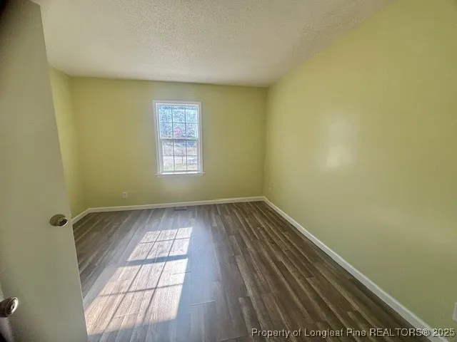 a view of wooden floor and windows in a room