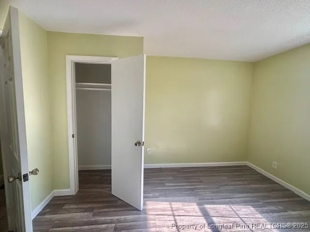 a view of a room with wooden floor and bench