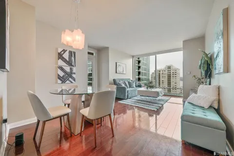 a view of a dining room with furniture wooden floor and a chandelier