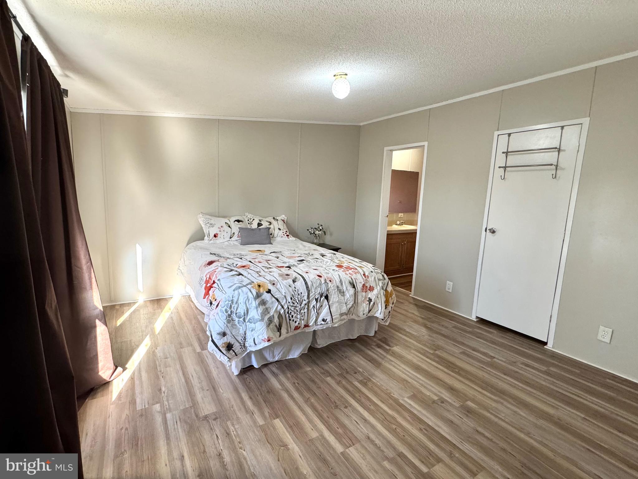 701 Cassel Road, Unit 105 Manchester, PA 17345 - Photo 20 of 35 a bedroom with a bed and wooden floor