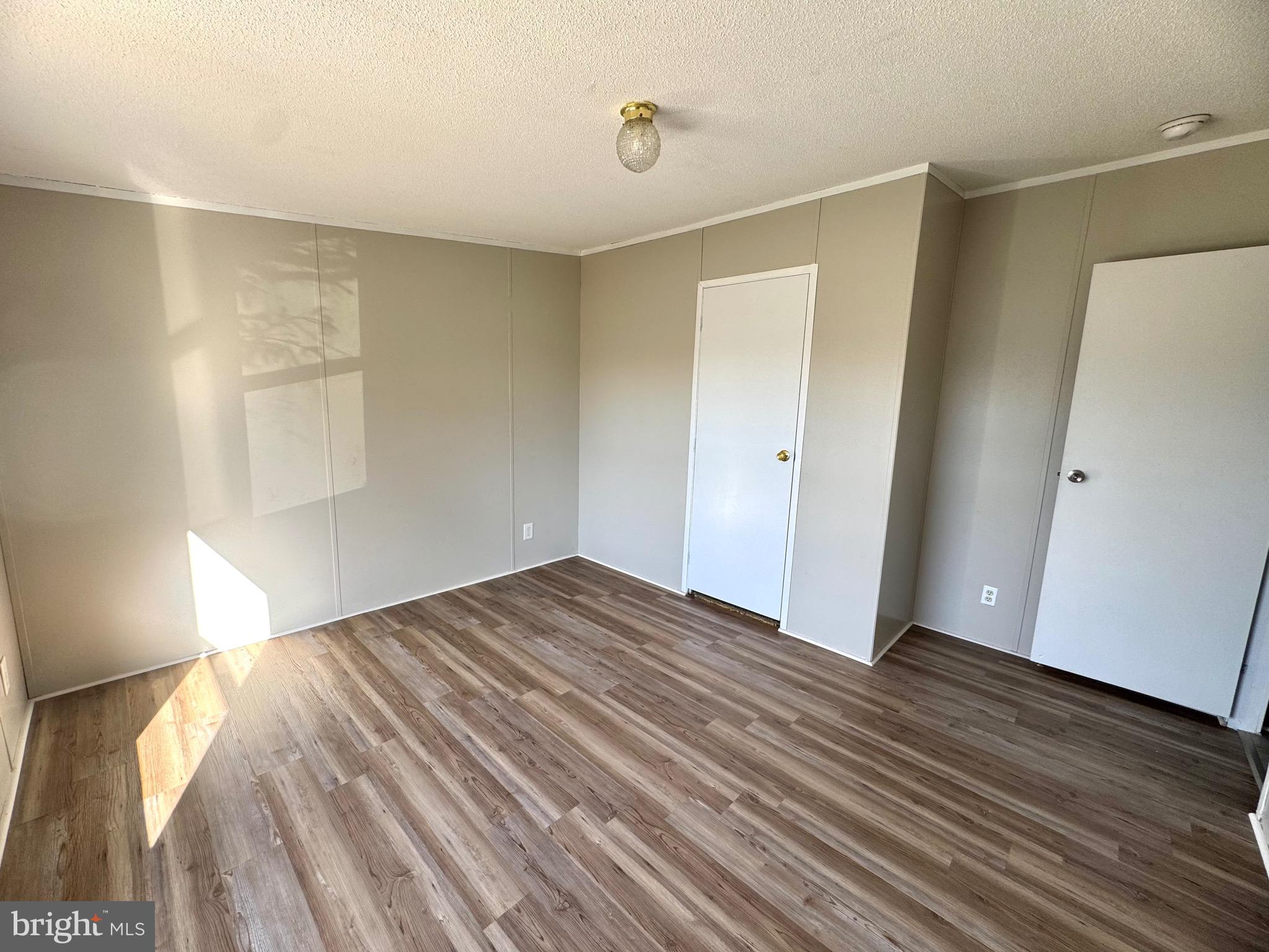 701 Cassel Road, Unit 105 Manchester, PA 17345 - Photo 27 of 35 a view of empty room with wooden floor and fan