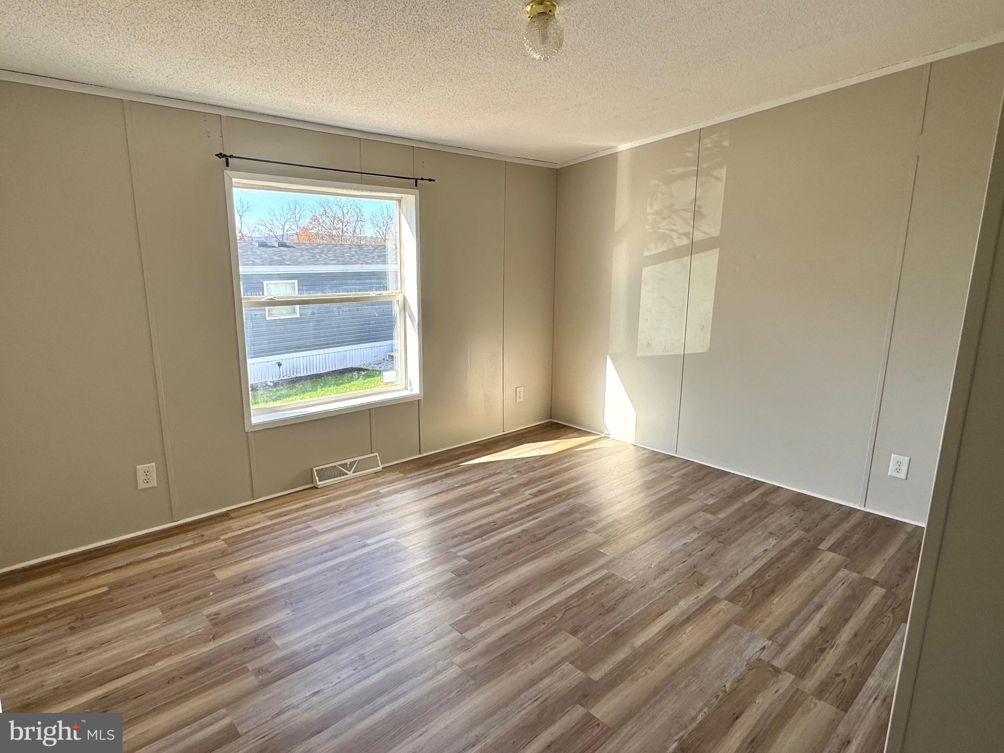 701 Cassel Road, Unit 105 Manchester, PA 17345 - Photo 29 of 35 an empty room with wooden floor and windows