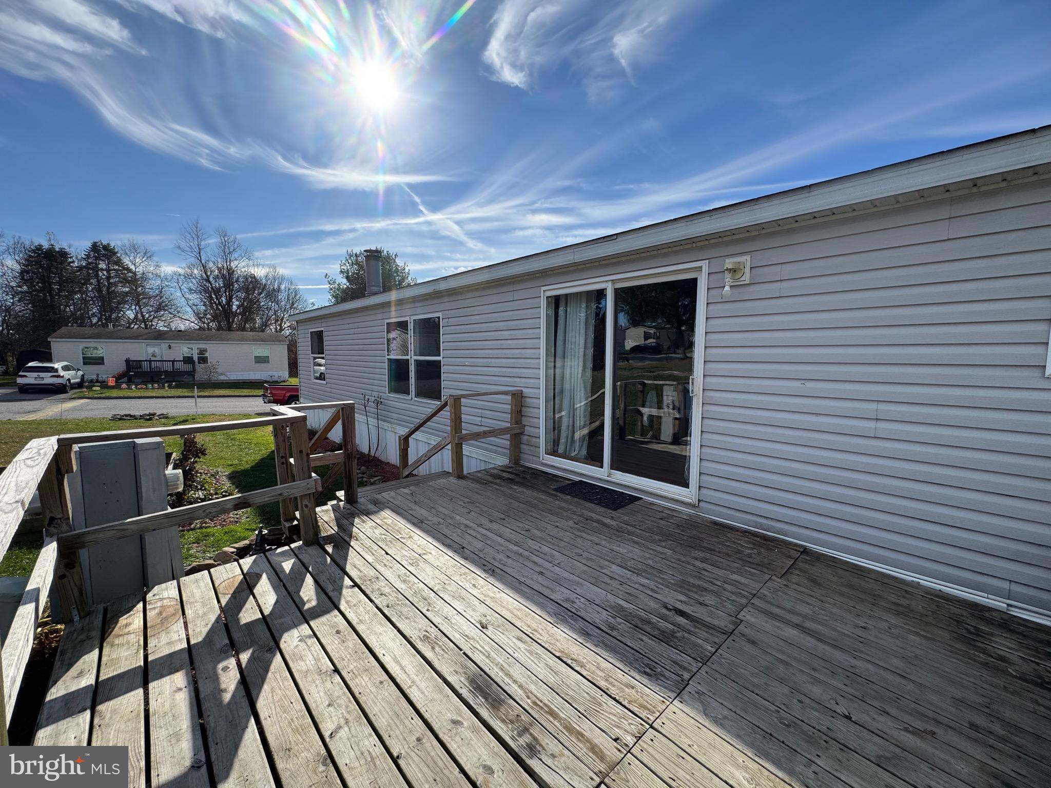 701 Cassel Road, Unit 105 Manchester, PA 17345 - Photo 5 of 35 a view of a patio with table and chairs barbeque oven and wooden floor