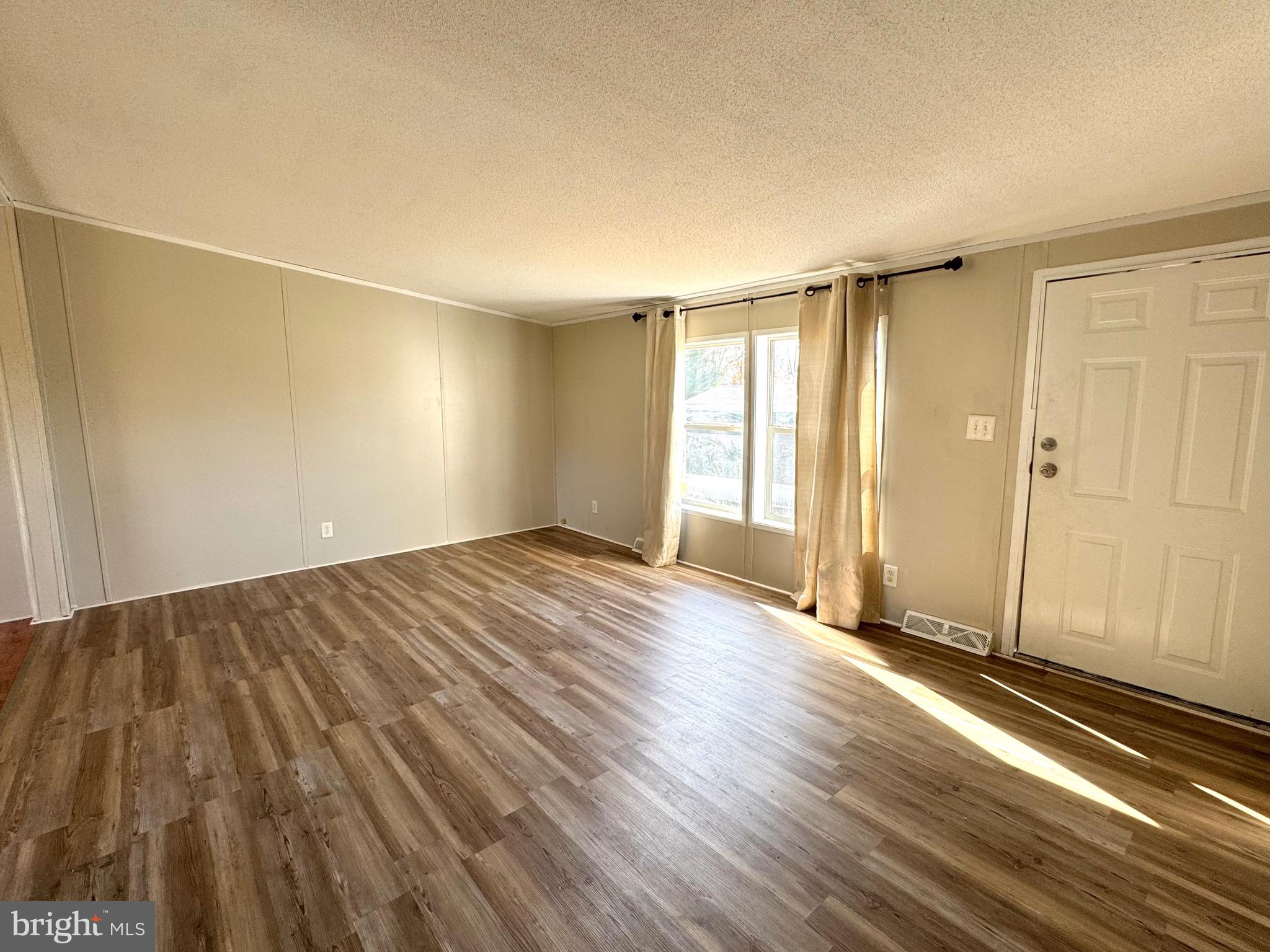 701 Cassel Road, Unit 105 Manchester, PA 17345 - Photo 6 of 35 an empty room with wooden floor and windows