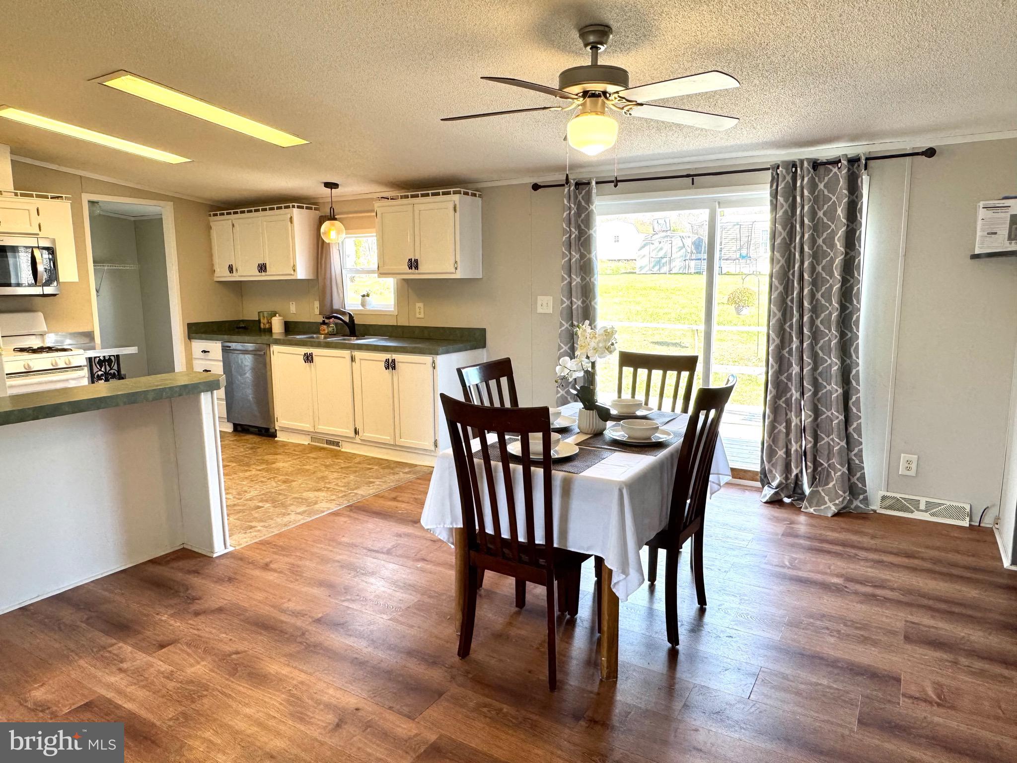 701 Cassel Road, Unit 105 Manchester, PA 17345 - Photo 8 of 35 a view of a dining room with furniture window and wooden floor