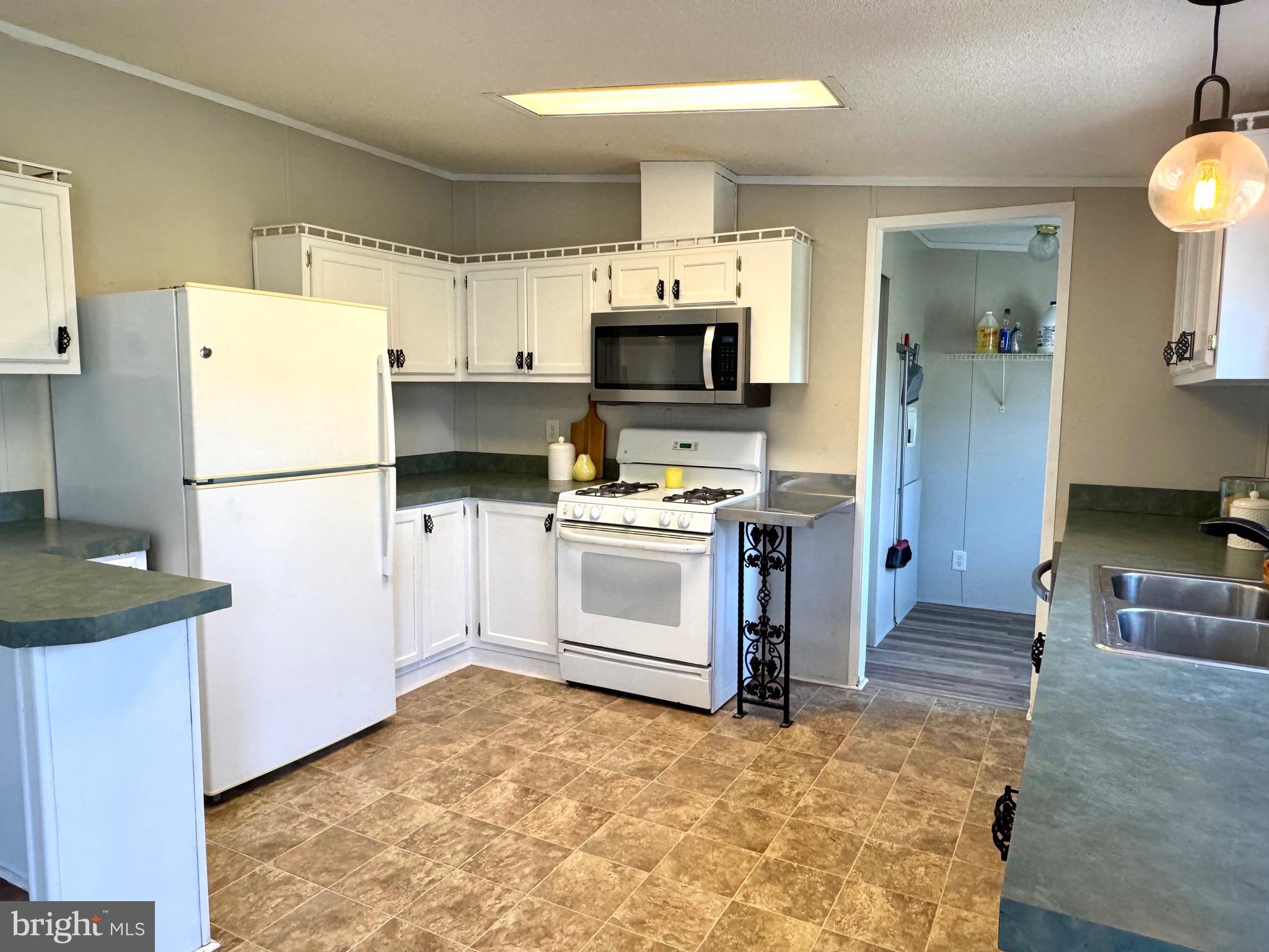 701 Cassel Road, Unit 105 Manchester, PA 17345 - Photo 10 of 35 a kitchen with a refrigerator and a stove top oven