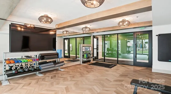 a room with lots of flat screen tv and a large window