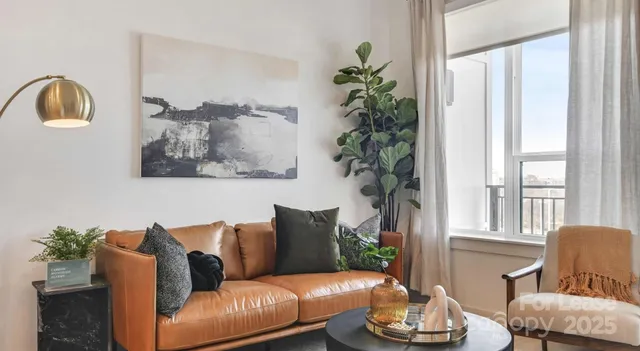 a living room with furniture and a potted plant