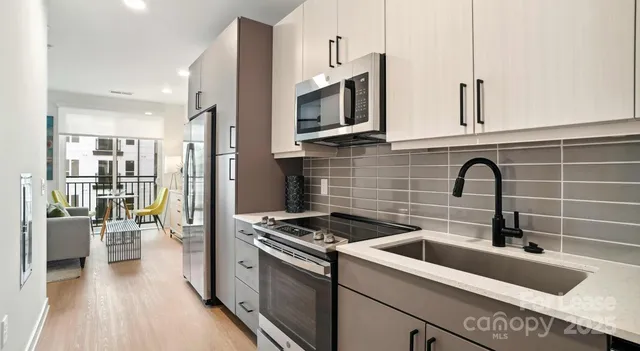 a kitchen with stainless steel appliances a stove sink and cabinets