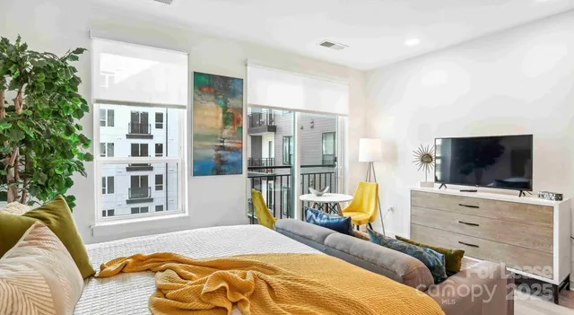 a bedroom with a bed and flat screen tv