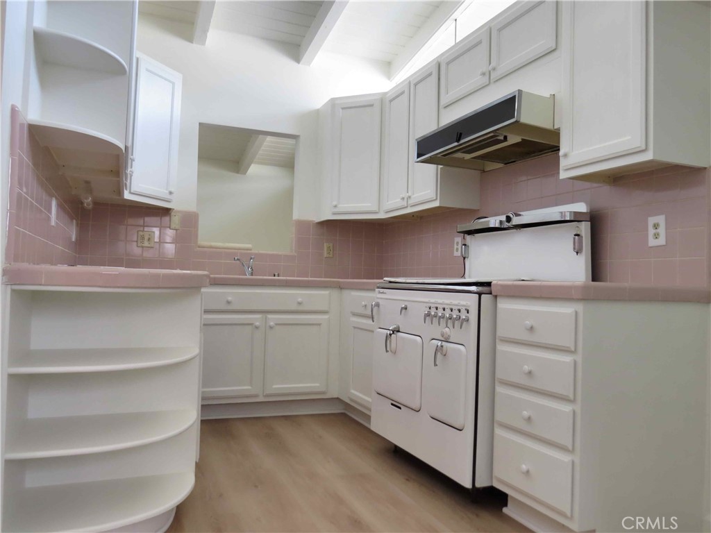 8159 Tunney Avenue Reseda, CA 91335 - Photo 13 of 33 a kitchen with white cabinets and white appliances