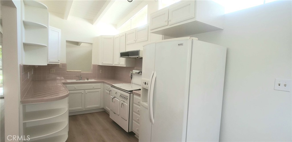 8159 Tunney Avenue Reseda, CA 91335 - Photo 14 of 33 a kitchen with stainless steel appliances a refrigerator and cabinets