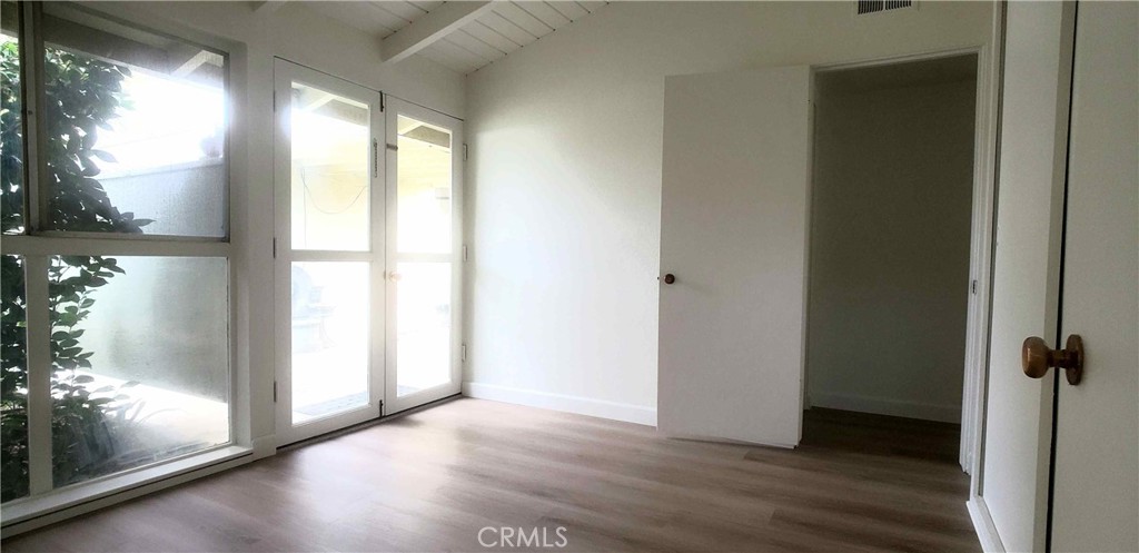 8159 Tunney Avenue Reseda, CA 91335 - Photo 16 of 33 a view of a room with wooden floor and door