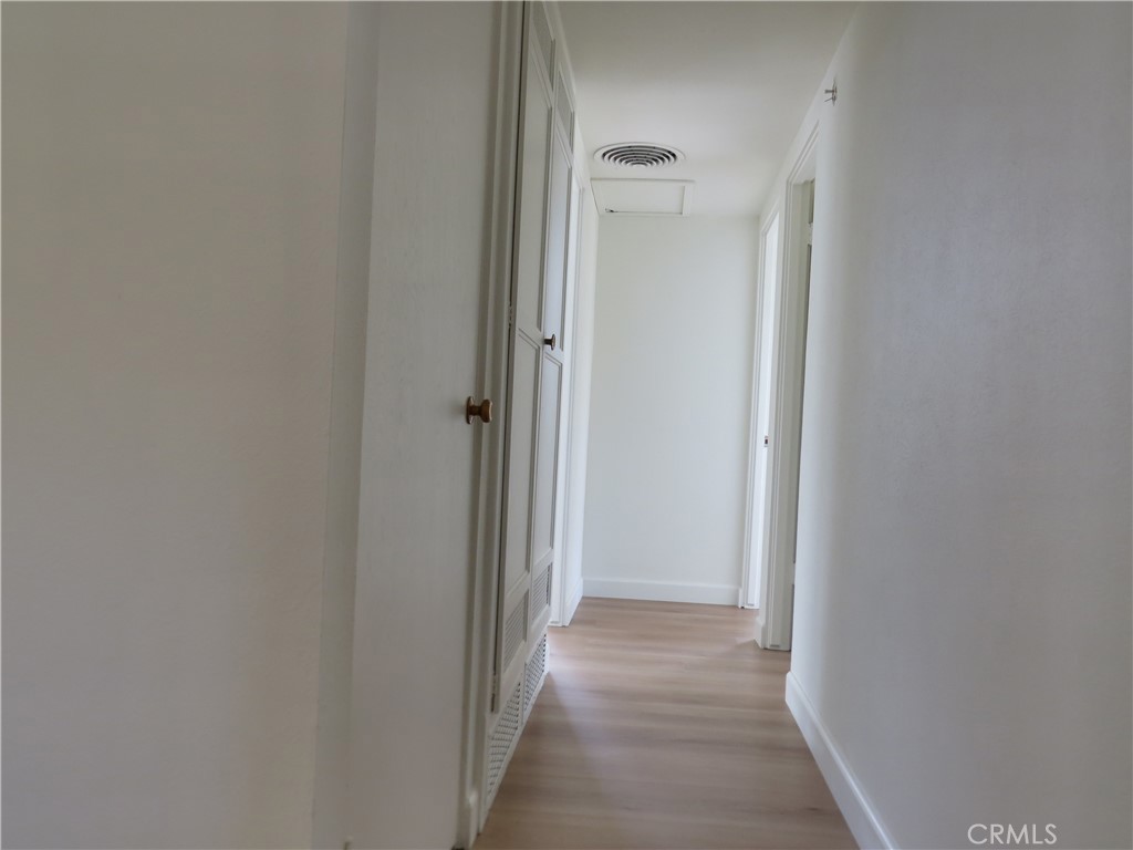 8159 Tunney Avenue Reseda, CA 91335 - Photo 20 of 33 a view of a hallway with a wooden floor