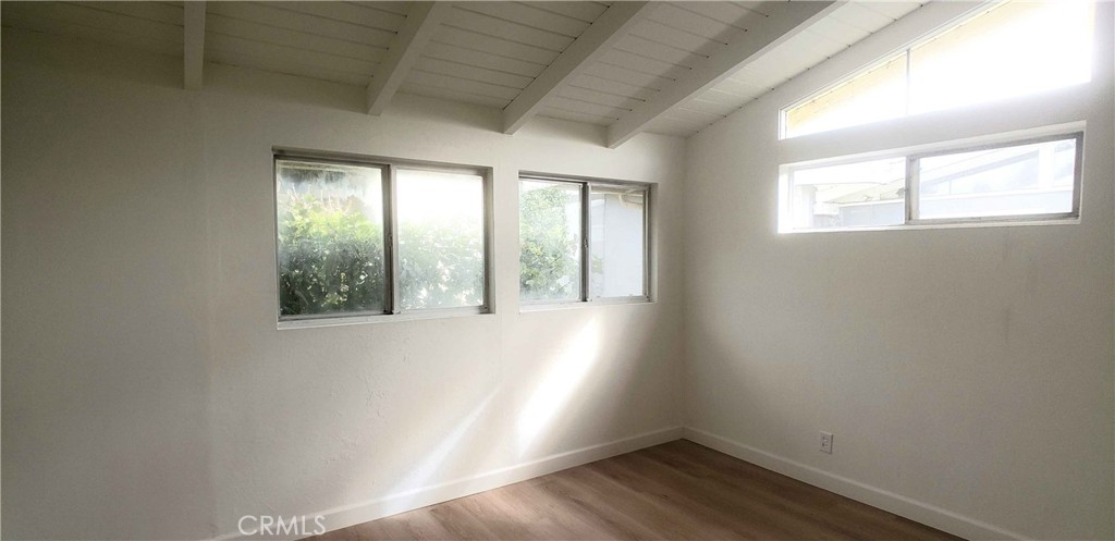 8159 Tunney Avenue Reseda, CA 91335 - Photo 21 of 33 an empty room with wooden floor and windows