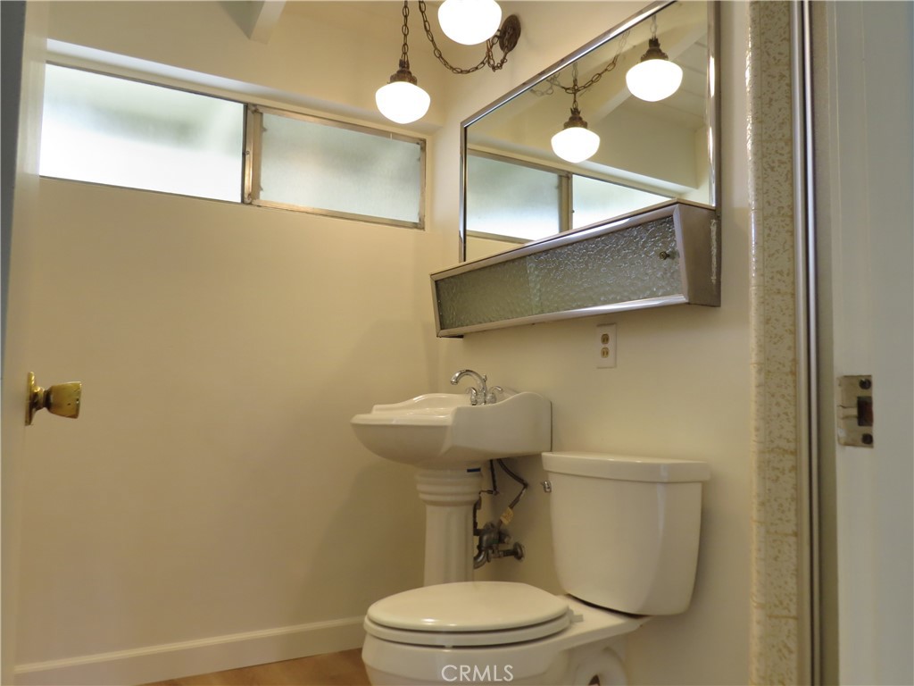 8159 Tunney Avenue Reseda, CA 91335 - Photo 27 of 33 a white toilet sitting next to a bathroom sink