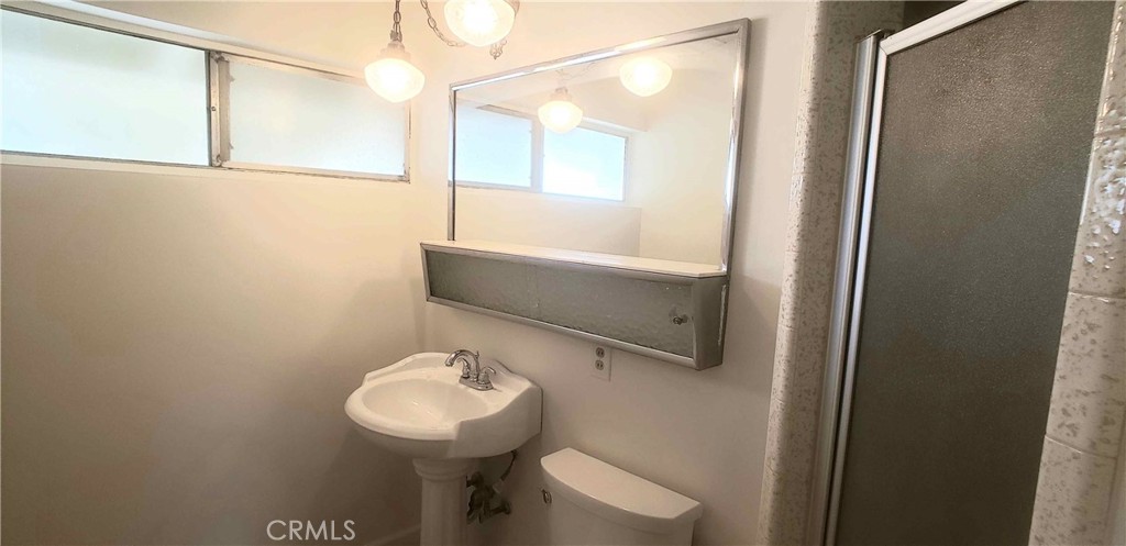 8159 Tunney Avenue Reseda, CA 91335 - Photo 28 of 33 a bathroom with a sink a toilet and shower