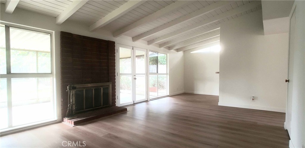 8159 Tunney Avenue Reseda, CA 91335 - Photo 9 of 33 a view of an empty room with wooden floor and a window