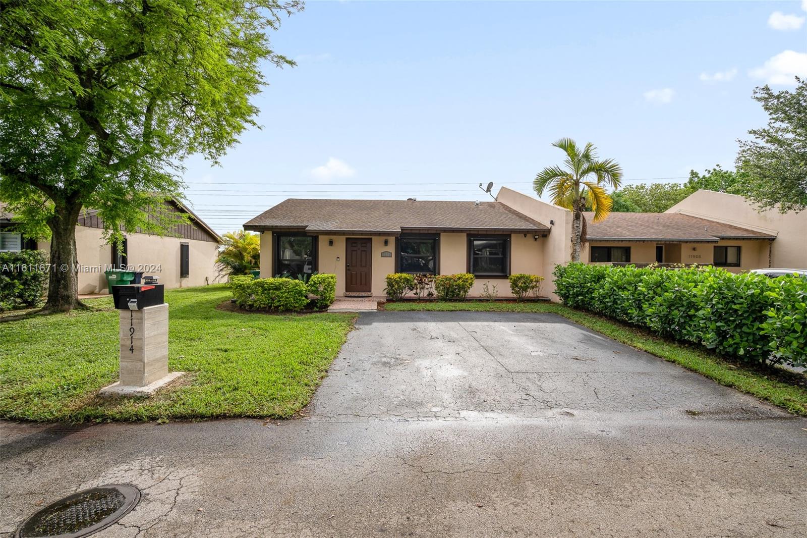 11914 Southwest 125th Place Miami, FL 33186 - Photo 1 of 31 a front view of a residential houses with yard and green space