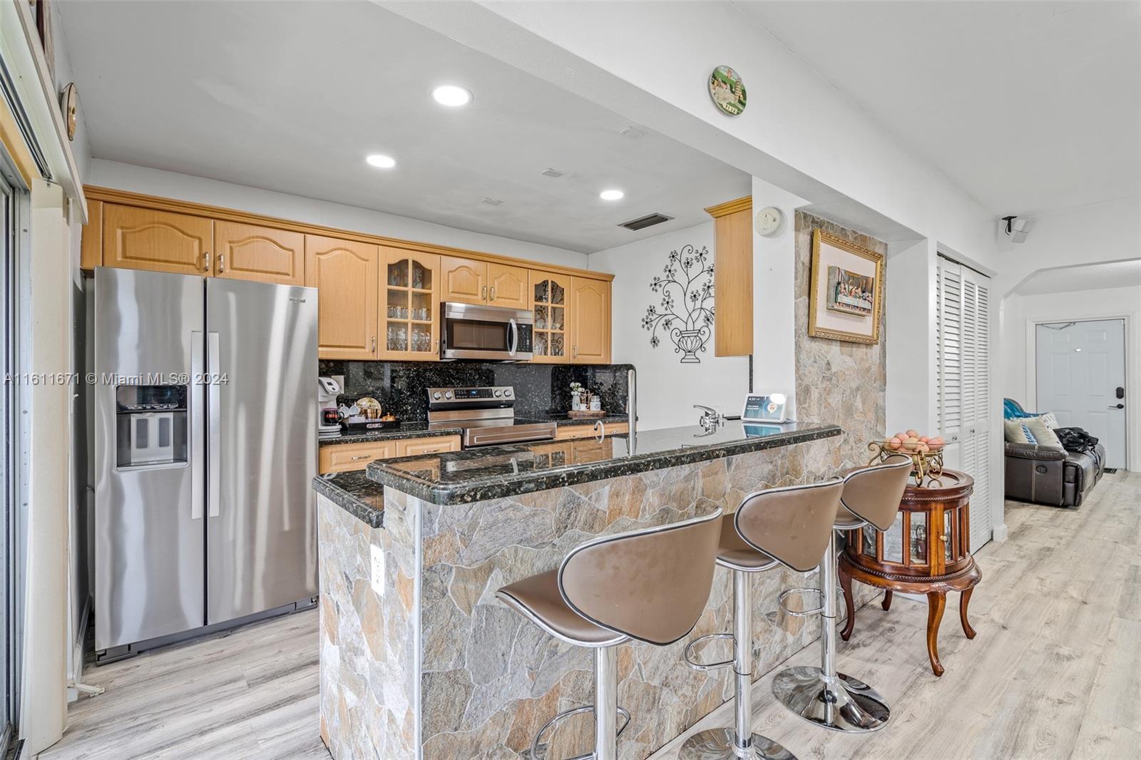 11914 Southwest 125th Place Miami, FL 33186 - Photo 12 of 31 a kitchen with stainless steel appliances granite countertop a refrigerator a sink a stove and island