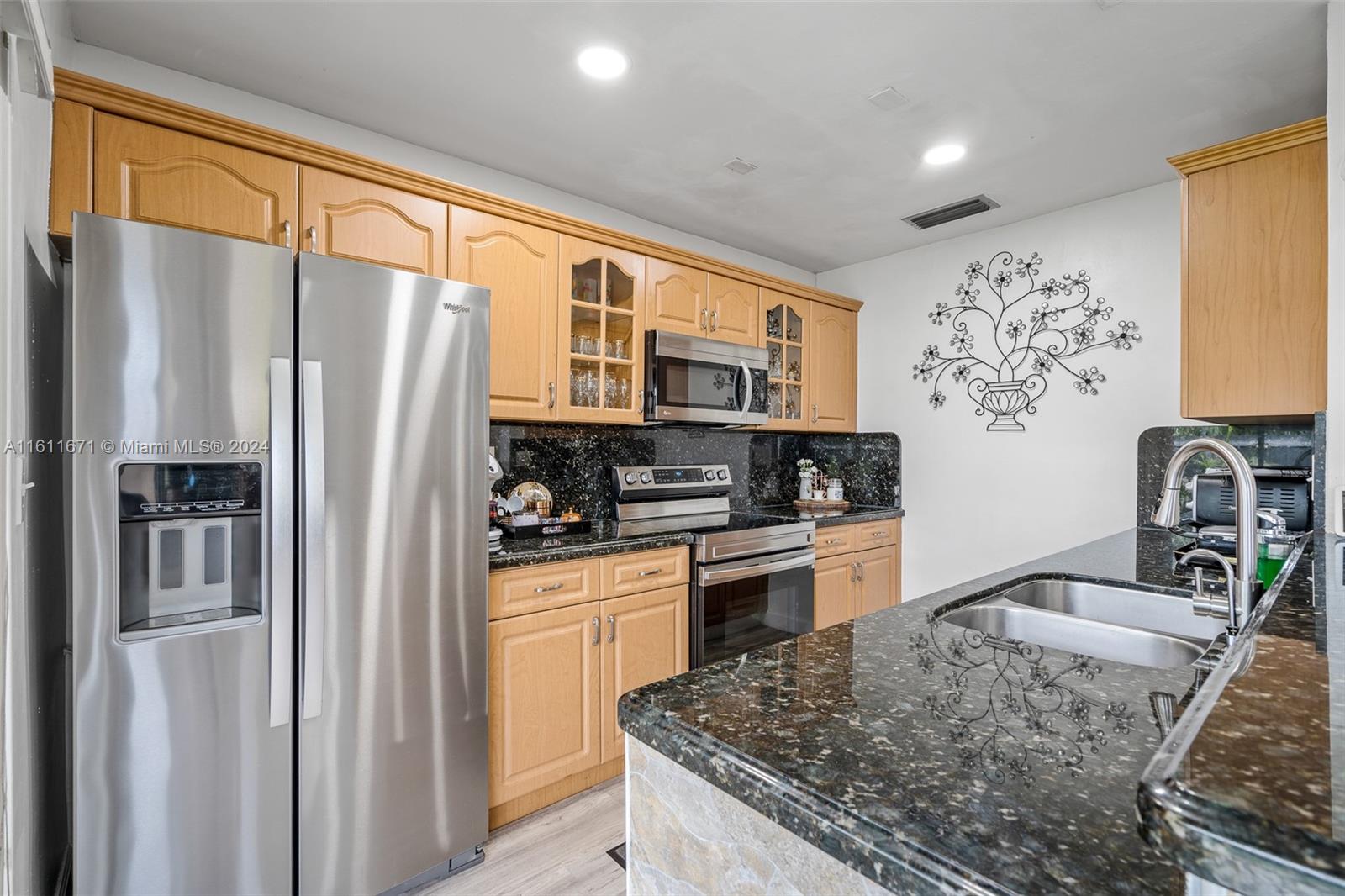 11914 Southwest 125th Place Miami, FL 33186 - Photo 13 of 31 a kitchen with stainless steel appliances granite countertop a refrigerator sink and stove