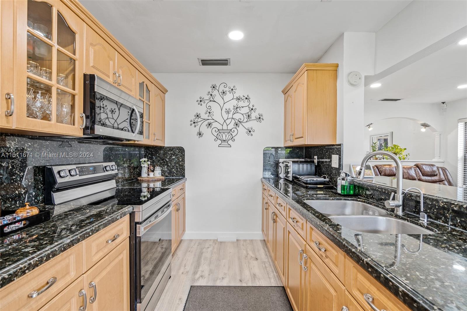 11914 Southwest 125th Place Miami, FL 33186 - Photo 14 of 31 a kitchen with stainless steel appliances granite countertop a sink stove and refrigerator